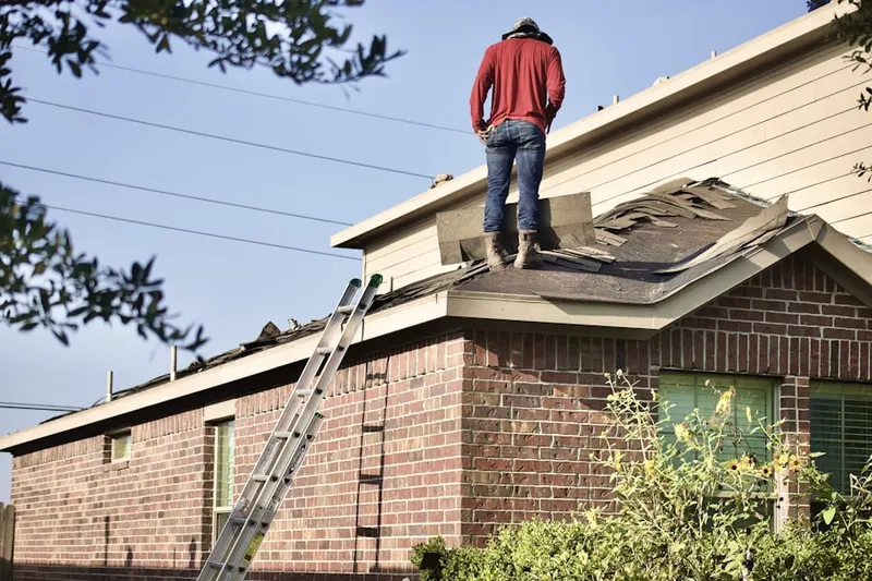 Professional roofer working on a residential roof in Merion Gardens